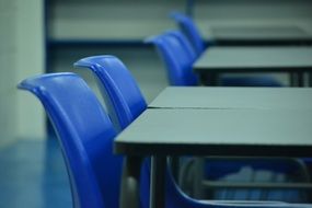 desks with blue chairs in the classroom
