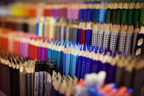 multicolored pencils and pens on a counter in a store