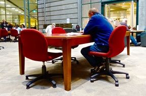 man Sitting at desk in library