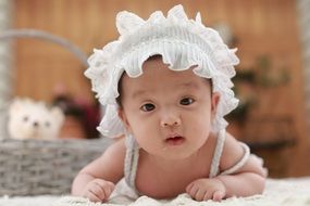 cute asian baby in the white hat