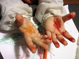 child's hands in paint