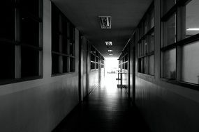 black and white photo of a corridor at school