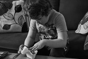 little autistic on the couch in black and white image