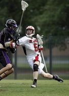 Lacrosse players on a field