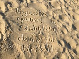 spelling words in the sand on the beach