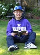 Asian student reads a book in the garden