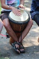 person plays Bongo drum outdoor