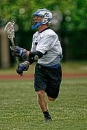 Man is playing Lacrosse