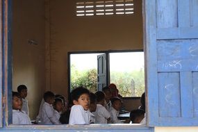 children in school class with open doors