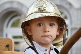 photo of a boy in a fireman helmet