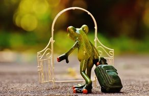 ceramic frog figure with suitcase
