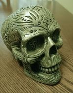 Small skull figurine with the ornaments made of metal