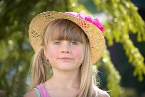 girl in a hat with a pink flower