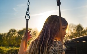 Girl on the swing in summer