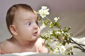 little baby and white delicate flowers