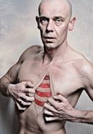 the man spreads the skin on his chest drawing