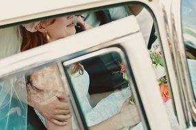 bride is sitting in a car