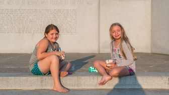 happy girls in the rays of the setting sun