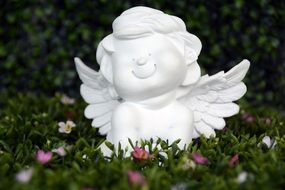 picture of the white angel figure is on a grass