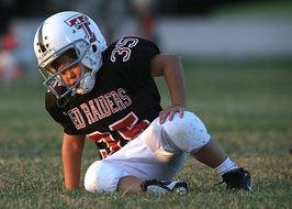 soccer player lies on the field in the youth league