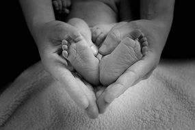 baby feet in mom's hands