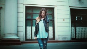 beautiful girl in jeans on a city street
