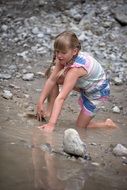 girl playing with mud