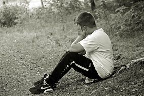hopeless boy sitting on jacket