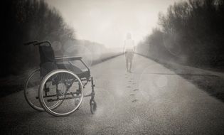 Wheelchair on the road in the fog