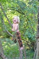 happy blonde Kid Climbing Tree