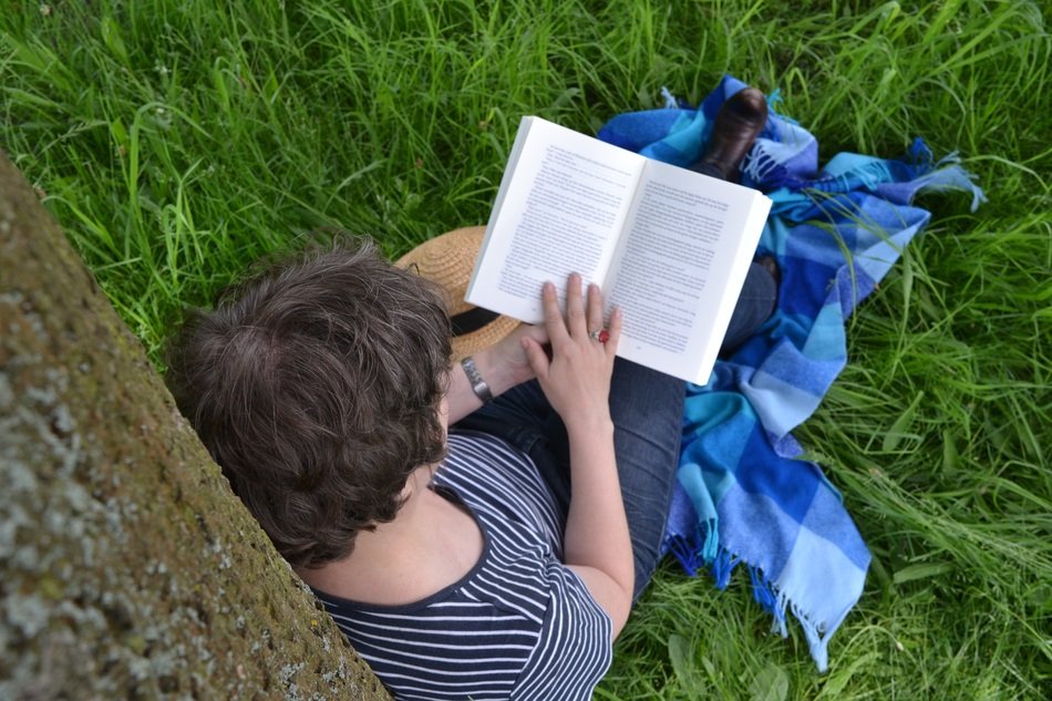 woman with a book among nature