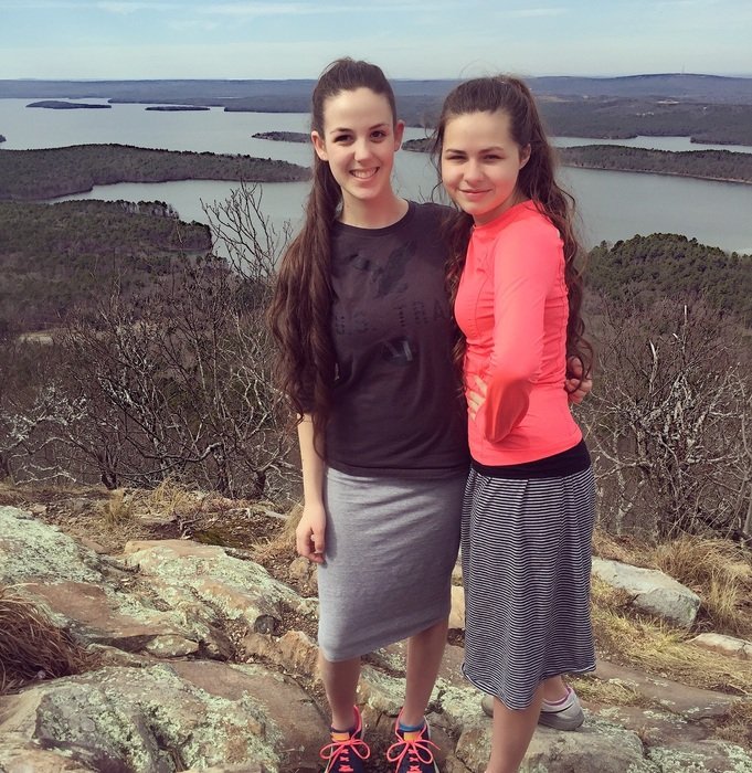 two girlfriends on the stone bank of the river