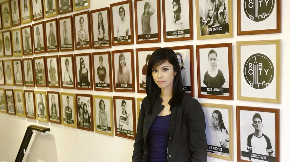 girl near the wall with photos