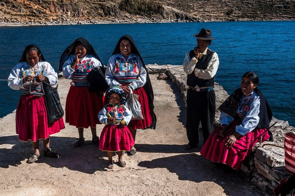 women and children in costumes near the river