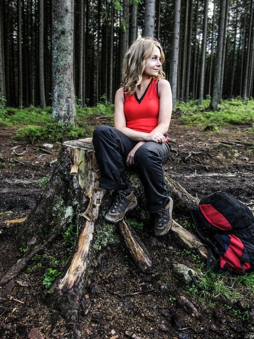 girl with a backpack in the forest
