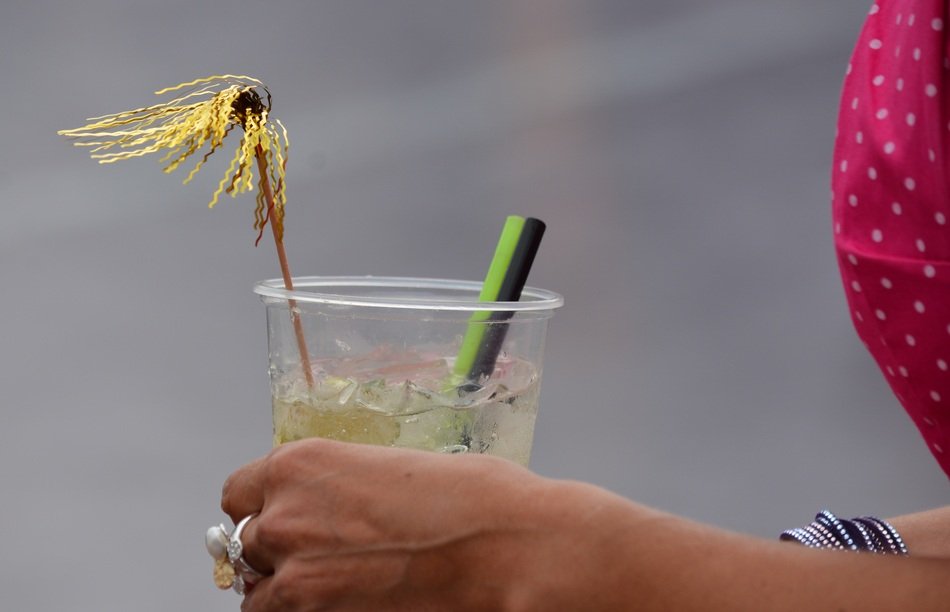 plastic cup with Alcohol Drink in female hand