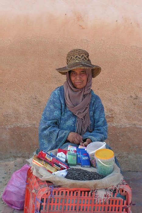 Woman Sales seeds and cigarettes on street