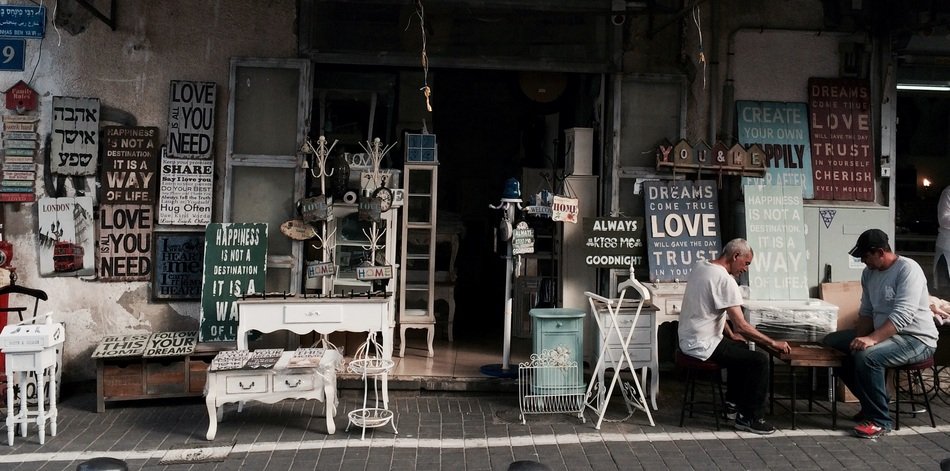 people on the background of shops with signages