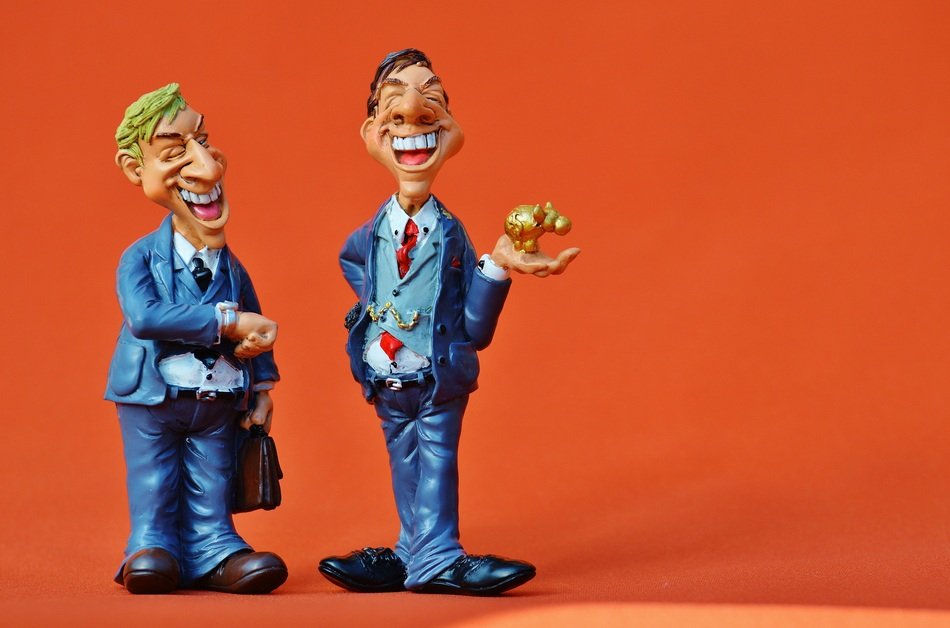 ceramic figures of men on an orange background