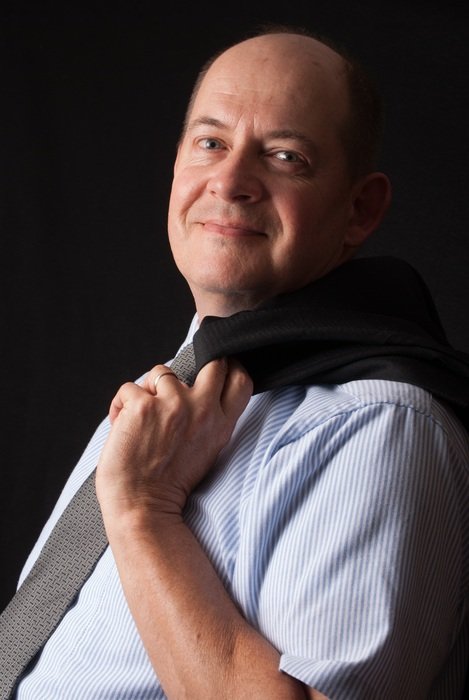 portrait of a businessman in a shirt on a black background