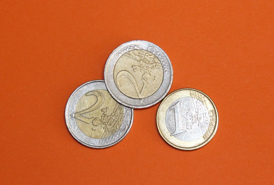 euro coins on an orange background