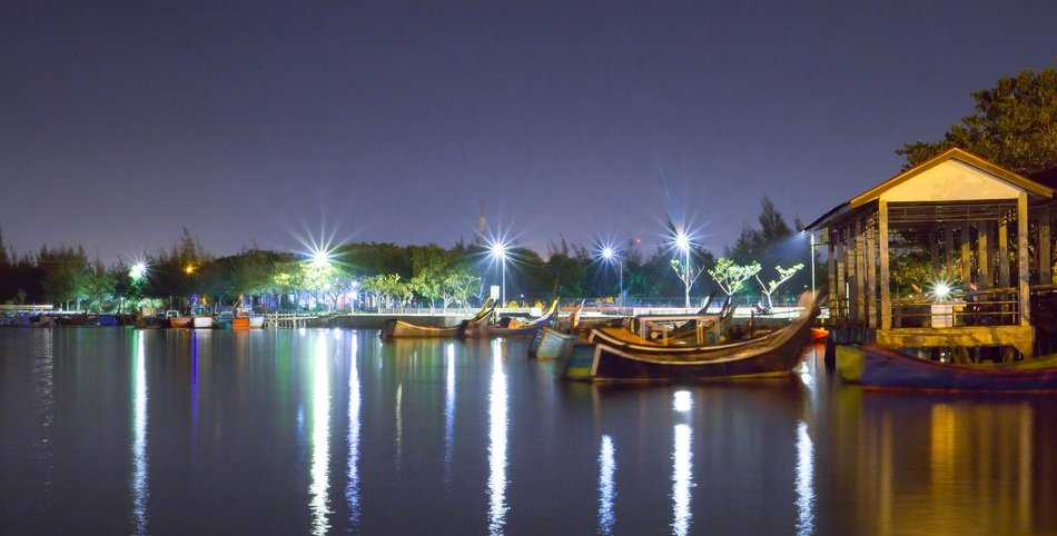 boats near the lighted pier