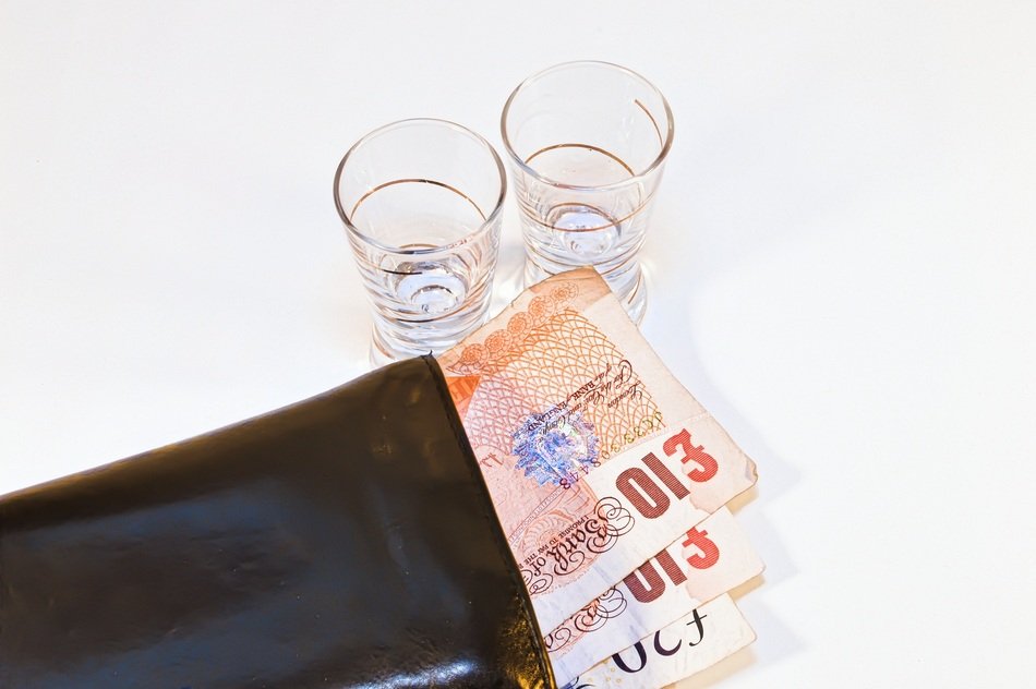wine glasses and wallet with banknotes