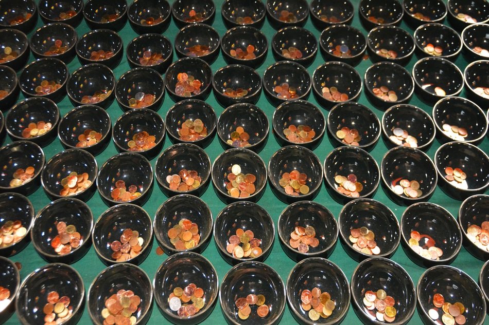 lot of black Bowls with coins