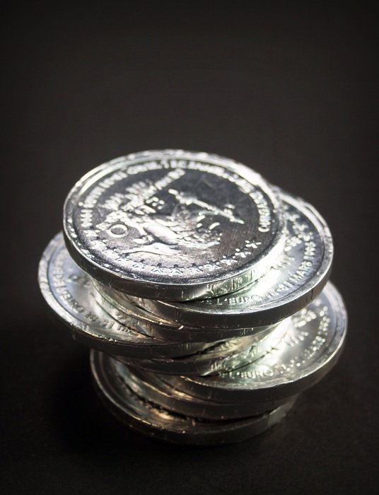 tower of coins on the black background