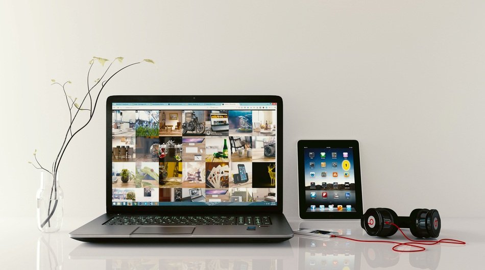 Workplace with headphones, tablet and laptop