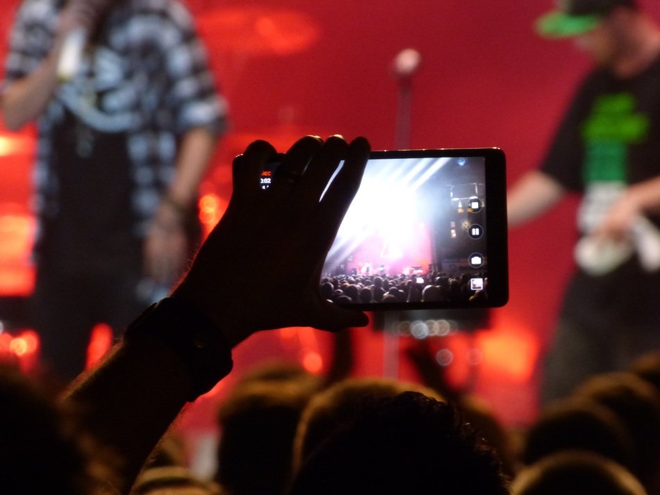 phone in hands at a concert on a blurred background