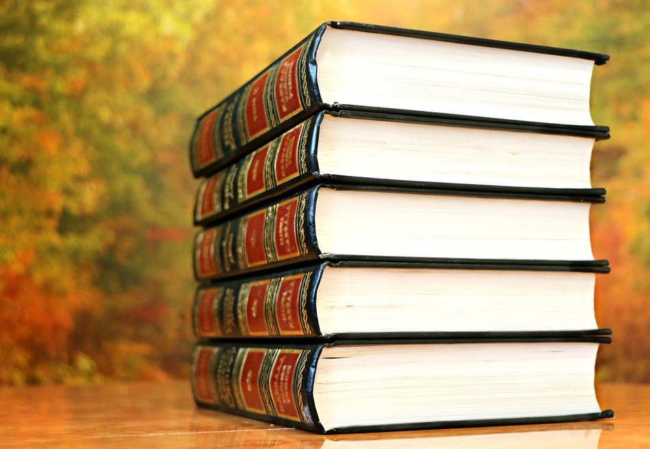 pile of hardcover Books on table