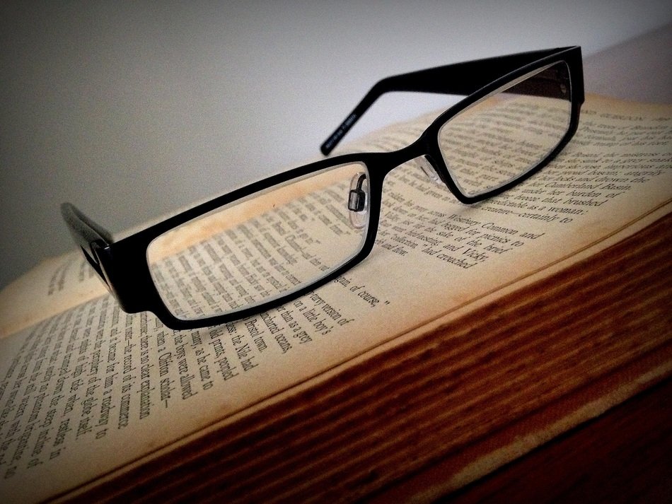 black glasses on the book