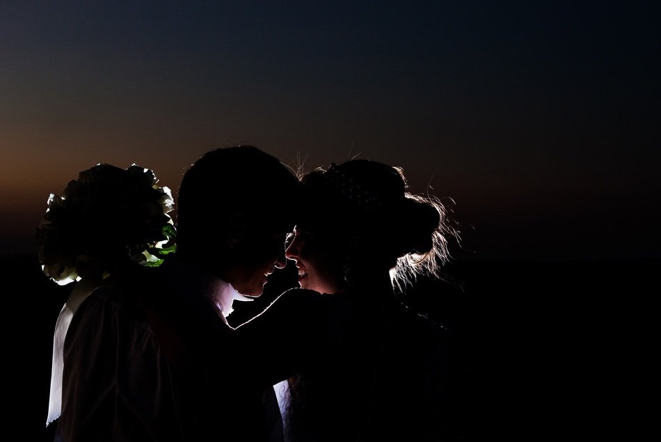 silhouettes of the newlyweds at dusk